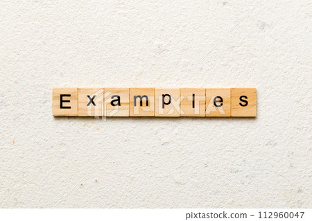 examples word written on wood block. examples text on table, concept examples word written on wood block. examples text on table, concept 112960047