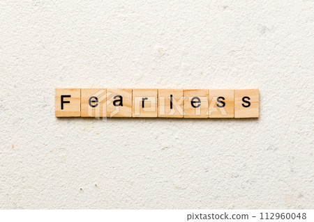 Fearless word written on wood block. Fearless text on cement table for your desing, concept Fearless word written on wood block. Fearless text on cement table for your desing, concept 112960048