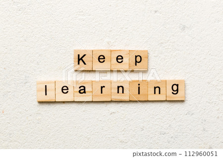 keep learning word written on wood block. keep learning text on table, concept 112960051
