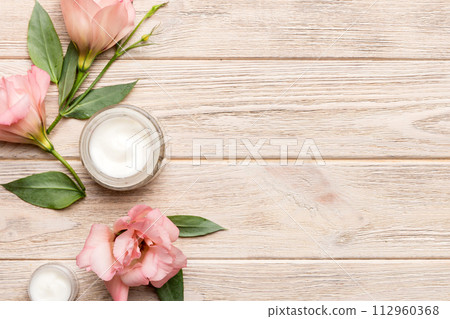 Composition with cosmetic products and beautiful roses on wooden background. Copy space, flat lay 112960368