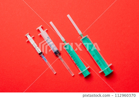 Top view of medical syringes on colorful background. Health care concept with copy space Top view of medical syringes on colorful background. Health care concept with copy space 112960370