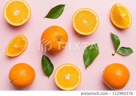 Fruit pattern of fresh orange slices on colored background. Top view. Copy Space. creative summer concept. Half of citrus in minimal flat lay 112960378