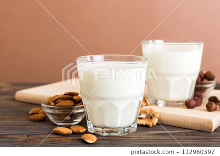 Set or collection of various vegan milk almond, cashew, on table background. Vegan plant based milk and ingredients, top view Set or collection of various vegan milk almond, cashew, on table background. Vegan plant based milk and ingredients, top view 112960397