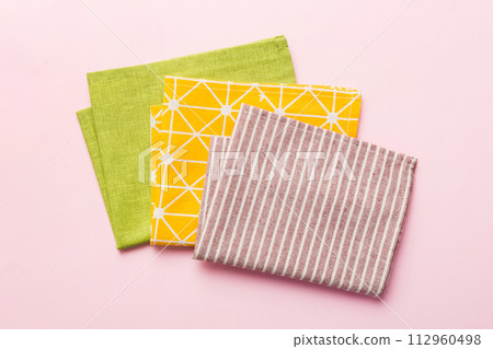 top view with red empty kitchen napkin isolated on table background. Folded cloth for mockup with copy space, Flat lay. Minimal style top view with red empty kitchen napkin isolated on table background. Folded cloth for mockup with copy space, Flat lay. Minimal style 112960498