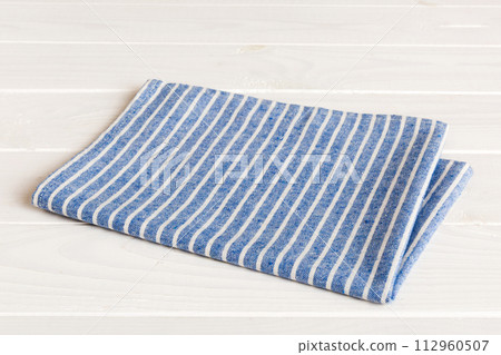 top view with blue kitchen napkin isolated on table background. Folded cloth for mockup with copy space, Flat lay. Minimal style top view with blue kitchen napkin isolated on table background. Folded cloth for mockup with copy space, Flat lay. Minimal style 112960507