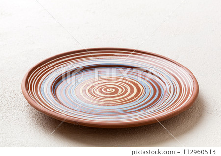 Perspective view of empty grey plate on cement background. Empty space for your design 112960513