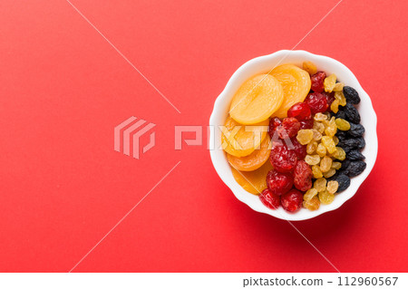 Bowl with different dried fruits on table background, top view. Healthy lifestyle with copy space Bowl with different dried fruits on table background, top view. Healthy lifestyle with copy space 112960567