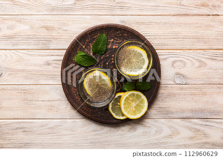 Healthy breakfast or morning with chia seeds lemon and mint on table background, vegetarian food, diet and health concept. Chia pudding with lemon and mint 112960629
