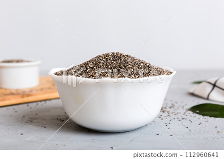 Chia seeds in bowl on colored background. Healthy Salvia hispanica in small bowl. Healthy superfood 112960641