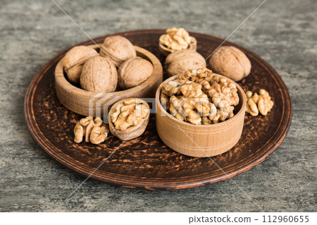 Fresh healthy walnuts in bowl on colored table background. Top view Healthy eating bertholletia concept. Super foods 112960655