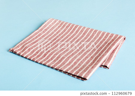 top view with red empty kitchen napkin isolated on table background. Folded cloth for mockup with copy space, Flat lay. Minimal style top view with red empty kitchen napkin isolated on table background. Folded cloth for mockup with copy space, Flat lay. Minimal style 112960679