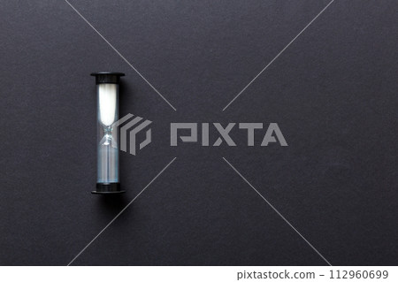 hourglass on the table, sand clock as time passing concept for business deadline, copy space hourglass on the table, sand clock as time passing concept for business deadline, copy space 112960699