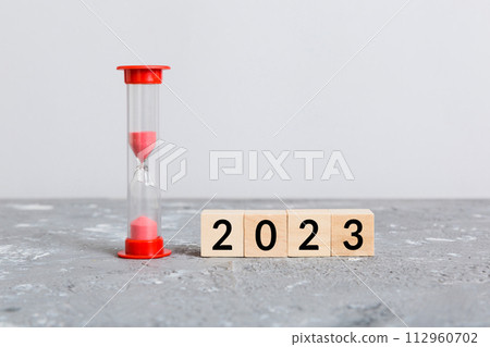 New Year 2023 sand timer. Resolution, time, plan, goal, motivation, reboot, countdown and New Year holiday concepts. Hourglass with number 2023 112960702