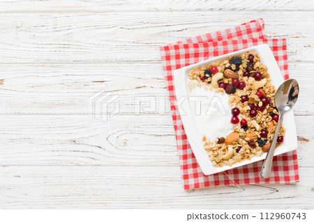 Healthy breakfast food with granola, yogurt, fruits and nuts. Dessert parfait with dried fruits for breakfast Healthy breakfast food with granola, yogurt, fruits and nuts. Dessert parfait with dried fruits for breakfast 112960743