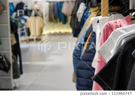 A second hand clothes shop in the center of the city with a lot of clothes A second hand clothes shop in the center of the city with a lot of clothes 112960747