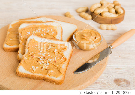 Peanut butter sandwiches or toasts on light table background.Breakfast. Vegetarian food. American cuisine top view vith copy space 112960753