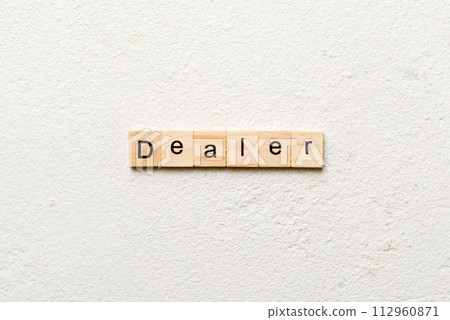 Dealer word written on wood block. Dealer text on cement table for your desing, concept 112960871