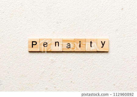 PENALTY word written on wood block. PENALTY text on cement table for your desing, concept 112960892