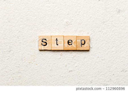 step word written on wood block. step text on table, concept step word written on wood block. step text on table, concept 112960896
