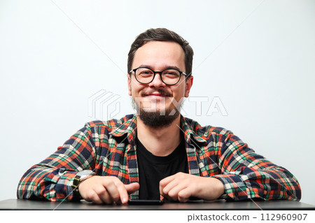 Portrait of young smiling caucasian man on white background. Man wearing eyeglasses, watch and casual denim shirt, isolated on white 112960907