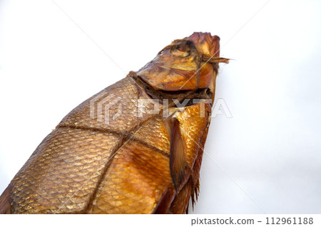 Smoked freshwater common bream fish for home use on white paper.. 112961188