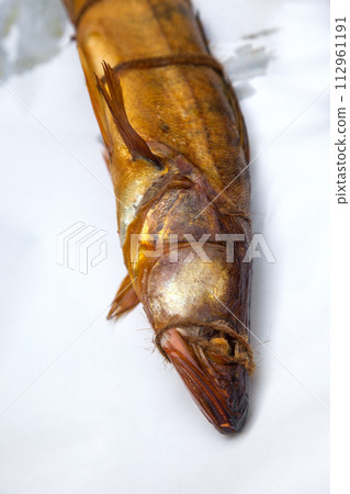 Smoked freshwater zander fish for home use on white paper.. 112961191