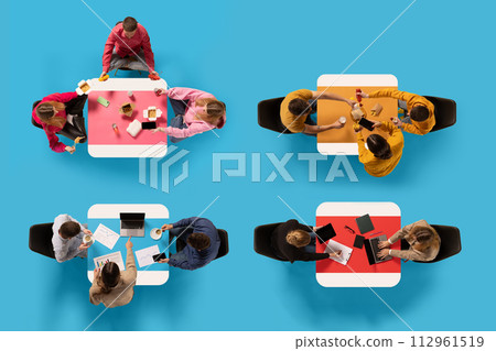Top view of four groups of people engaged in various activities around different colored tables against blue background. 112961519