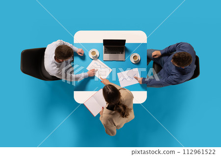 Creative collage. Business people sit at common table with documents and planning on meeting against blue studio background. 112961522