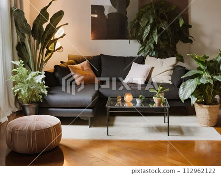 Stylish black-based living room with houseplants and an L-shaped sofa Stylish black-based living room with houseplants and an L-shaped sofa 112962122
