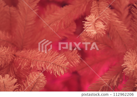 Close up top view of pink Christmas tree with copy space. Background with pine branches with selective focus, bokeh. Concept of greeting cards, congratulation, decor, textured background, wallpaper. 112962206