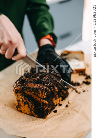 Person Slicing Homemade Poppy Seed Roll 112962323