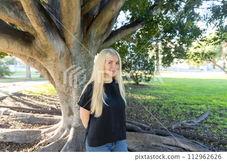 Woman with braces Standing by Tree in the park 112962626
