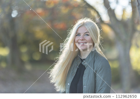 Woman with braces With Long Blonde Hair in Forest 112962650