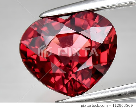 natural red rhodolite garnet gemstone on the background natural red rhodolite garnet gemstone on the background 112963569