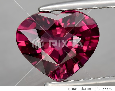 natural red rhodolite garnet gemstone on the background 112963570