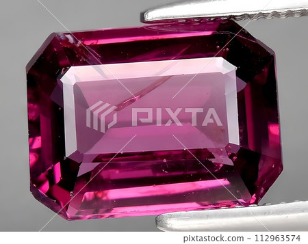 natural pink rhodolite garnet gemstone on the background 112963574