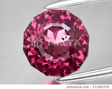 natural pink rhodolite garnet gemstone on the background natural pink rhodolite garnet gemstone on the background 112963576