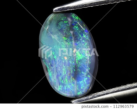 natural rainbow multi color opal gemstone on the background natural rainbow multi color opal gemstone on the background 112963579