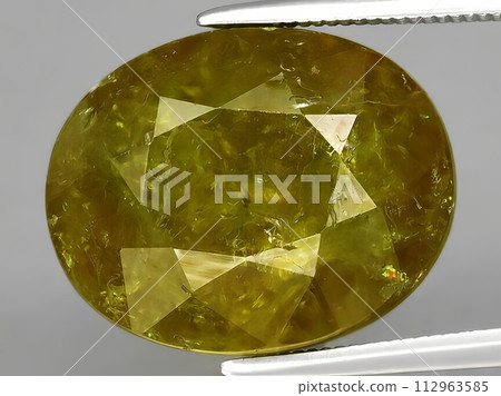 natural green yellow grossular garnet gemstone on the background natural green yellow grossular garnet gemstone on the background 112963585