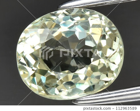 natural yellow grossular garnet gemstone on the background 112963589