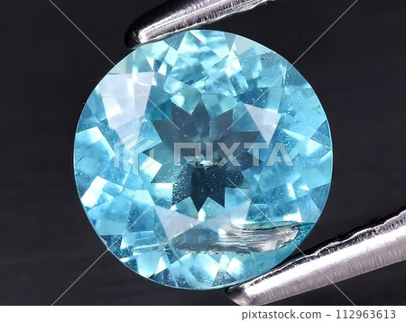 natural blue apatite gemstone on the background natural blue apatite gemstone on the background 112963613