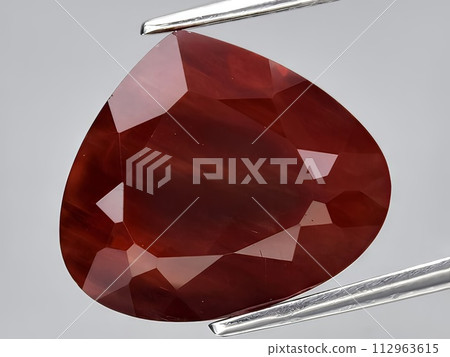 natural red orange andesine gemstone on the background natural red orange andesine gemstone on the background 112963615