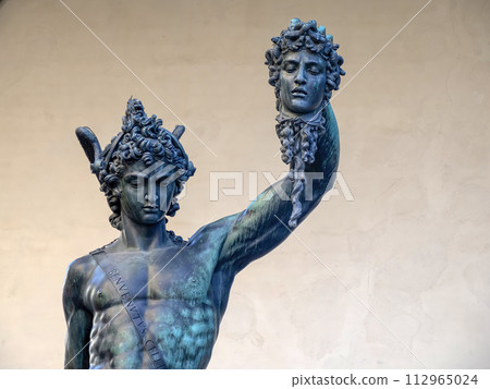 Detail of Perseus holding head of Medusa, bronze statue in Loggia de Lanzi, Piazza della Signoria, Florence, Italy. Isolated on white Detail of Perseus holding head of Medusa, bronze statue in Loggia de Lanzi, Piazza della Signoria, Florence, Italy. Isolated on white 112965024