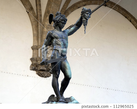 Detail of Perseus holding head of Medusa, bronze statue in Loggia de Lanzi, Piazza della Signoria, Florence, Italy. Isolated on white 112965025