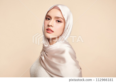 Beautiful young asian muslim woman wearing a white hijab on beige background, Portrait of Arab Beauty. 112966181