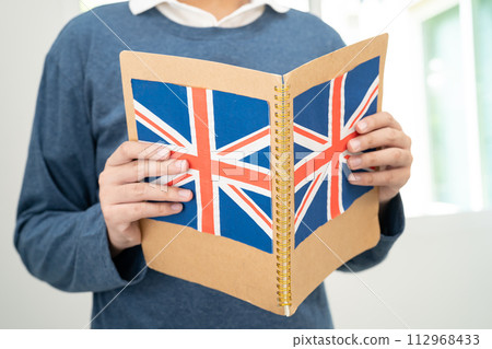 Learn English language, Asian teenage student hold book with flag in course at school. Learn English language, Asian teenage student hold book with flag in course at school. 112968433