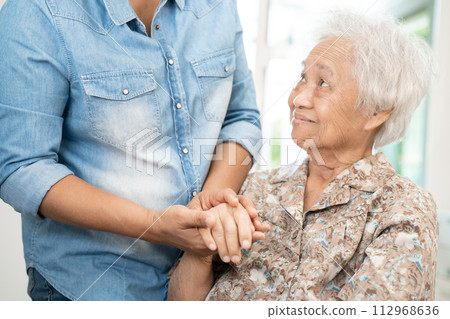 Caregiver help and care Asian senior woman patient with love, encourage and empathy in hospital. 112968636