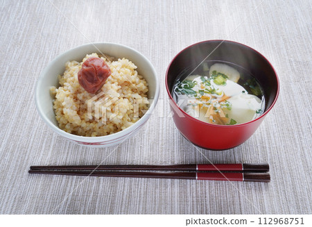 Japanese breakfast of freshly cooked brown rice with pickled plums and piping hot miso soup Japanese breakfast of freshly cooked brown rice with pickled plums and piping hot miso soup 112968751