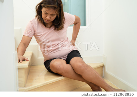Asian lady fall down the stairs and pain at hip and waist because slippery surfaces. Asian lady fall down the stairs and pain at hip and waist because slippery surfaces. 112968930