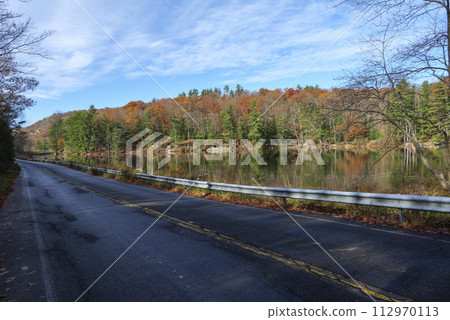 On a sunny cloudy day, the road along the lake in Upstate New York. On a sunny cloudy day, the road along the lake in Upstate New York. 112970113